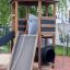 Wooden playground structure Six Angle Aztec with slide and climbing elements.