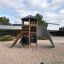 Six Angle Aztec playground structure with climbing wall and slide on sandy playground