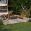 Sun Shade Square Pioneer with wooden frame and green canopy in a backyard seating area.