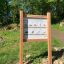 Rules Tab signboard with exercise instructions in a forest setting.
