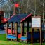 Outdoor playhouse structure for children in a park, named Rules Tab.
