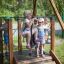 Children playing on Medium Cableway with platform in playground.