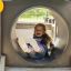 Child sliding down the Locomotive with slide train playhouse.
