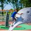 Boy climbing on Aztec arch steel structure in a playground
