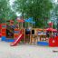 Colorful Bounty ship with slide playground equipment on sandy area surrounded by trees