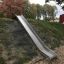 Hill Slide h210 on a grassy slope in a park playground
