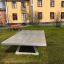 Concrete table tennis, free-standing in a park setting.