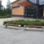 Geneva V benches in front of a modern building entrance