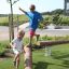 Children playing on a Ramp balance beam in a playground.