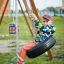 Child swinging on a Tire seat playground swing set.