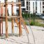 Outdoor Lemur single slide playground equipment on sandy playground with residential buildings in ba