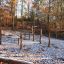 Outdoor bamboo playground set in a forest during autumn.