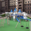 Playground structure Windsor castle with slide and swings in an outdoor residential area.