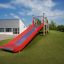 Outdoor playground slide Hill Slide Wide SLW150 on a grassy hill.