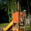 Sigma playground equipment with orange slide and climbing features