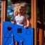 A child playing on the Bravo single playhouse.