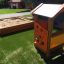 Bravo single playhouse on a playground next to a sandbox