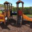 Smart playhouse with slide in a park setting