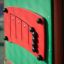 Smart playhouse with slide panel detail in green and red