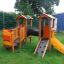 Children playing on a smart playhouse with slide.