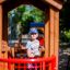 Child playing in a smart playhouse with slide