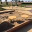 wooden sandpit with play tables