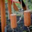Zebra single slide wooden playground equipment with hanging cylindrical logs.