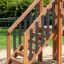 Wooden playground climbing ladder with black safety bars - Trap rock.