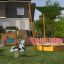 Sun Shade Triangle 3x3x3 Nature (Robinia) in a playground area with a spring rider, sandbox, and pla