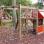 Little Jungle single slide playground equipment with climbing ropes and wooden structure in a park.