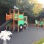 Playground set shaped like a tractor with slide and climbing features.