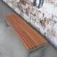 Kyoto bench made of exotic wood against a rustic wall