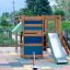Climbing Kiosk wooden playground structure with slide on safety mat flooring.