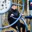 Woman exercising on outdoor gym equipment Set 6 in a park.