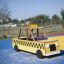 Wooden Taxi playground structure in a park, styled as a classic yellow cab.