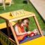Child playing in a Taxi-themed playground car.