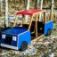 Blue and red wooden playground truck for kids.