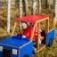 Children playing in a wooden truck-themed playground equipment.