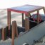 Wooden playground car named Truck with a red steering wheel.