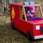 Children playing in a Fire brigade truck on grass.
