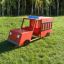 Fire brigade truck playground equipment on grassy area.