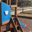 Police station playhouse with slide in a playground