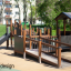 Gamma playground equipment with slide and climbing structures in a park setting