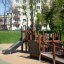 Gamma playground structure with slide and climbing features in an urban park