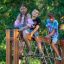 Children climbing and playing on V-shape Net Large playground equipment outdoors.
