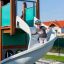 Majestic ship with slide on playground featuring a boy enjoying the slide