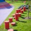 Red jumping pegs (5 pcs.) in playground.