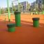 Green Jumping Pegs (5 pcs.) on an outdoor playground with orange rubber surfacing.