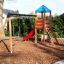 Double Swing with Tower playhouse with slide in a backyard playground