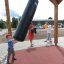 Child playing with a Punching bag on a playground.